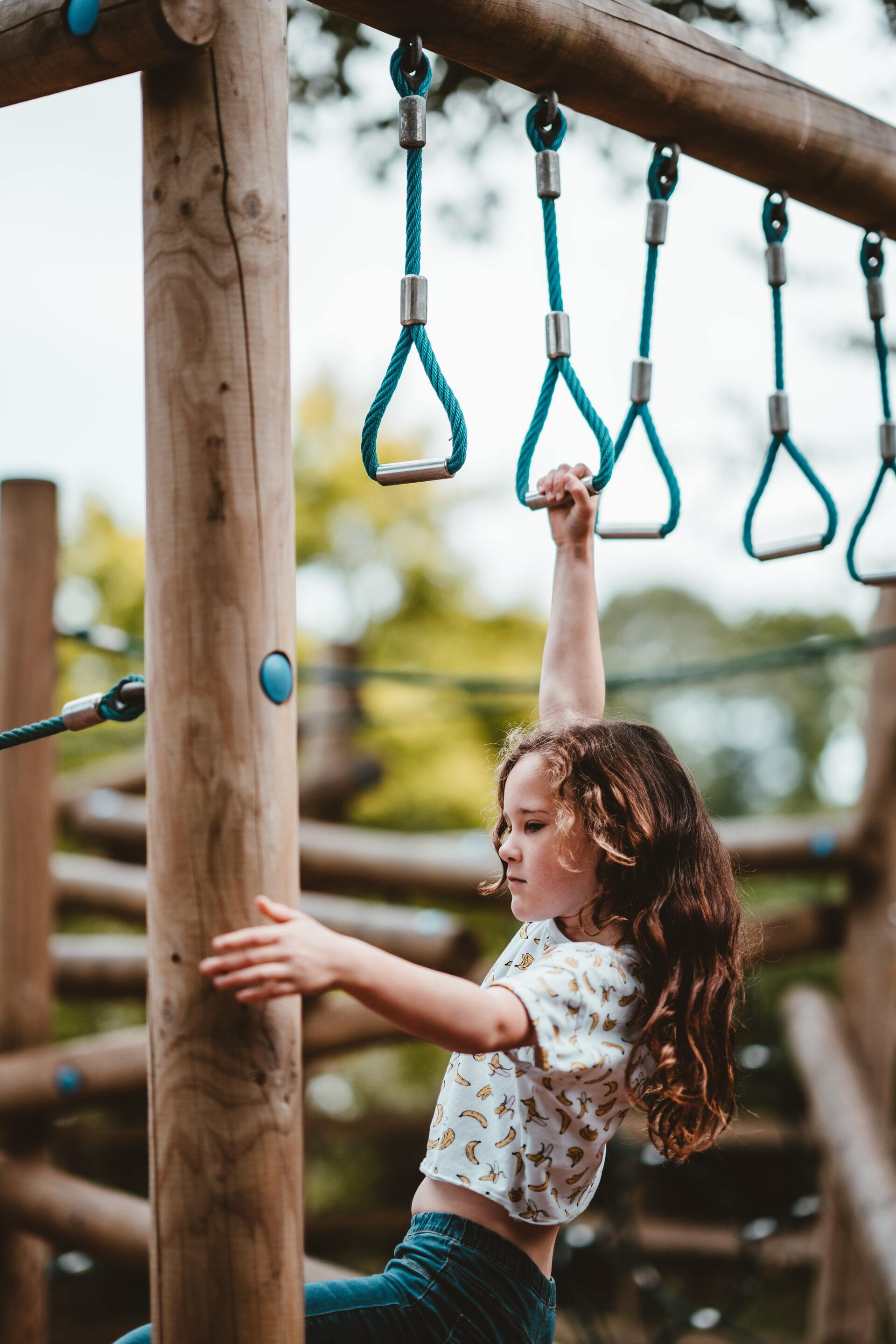 Girl swinging on monkey-bars